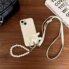 Camellia Flower and Puppy Pearl Charm Leather Crossbody Lanyard Phone Case for iPhone 16 Series